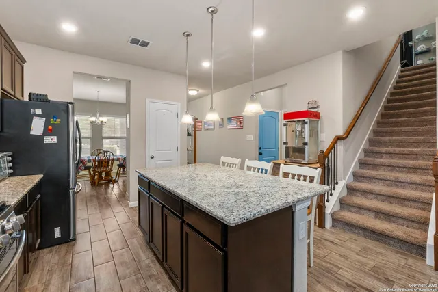 an open kitchen with a table and chairs