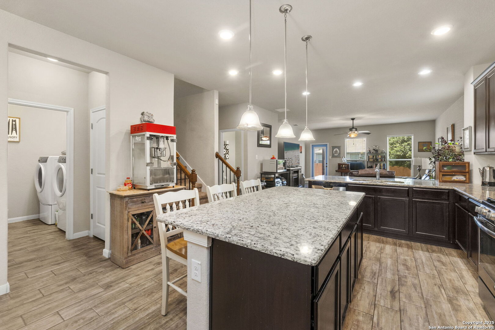 10343 Rosalina Loop Converse, TX 78109 - Photo 13 of 38 a kitchen with stainless steel appliances granite countertop sink refrigerator and wooden floor
