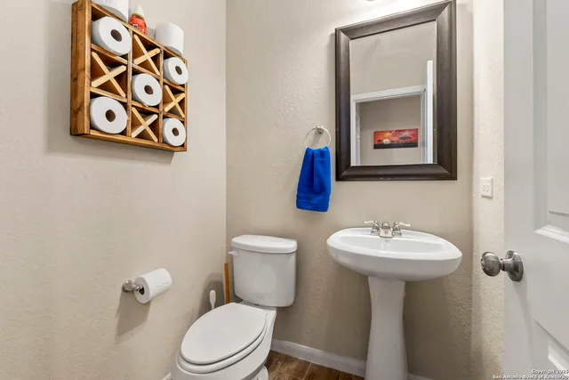 a bathroom with a toilet sink and mirror
