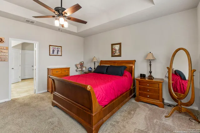 a bedroom with two beds and a desk
