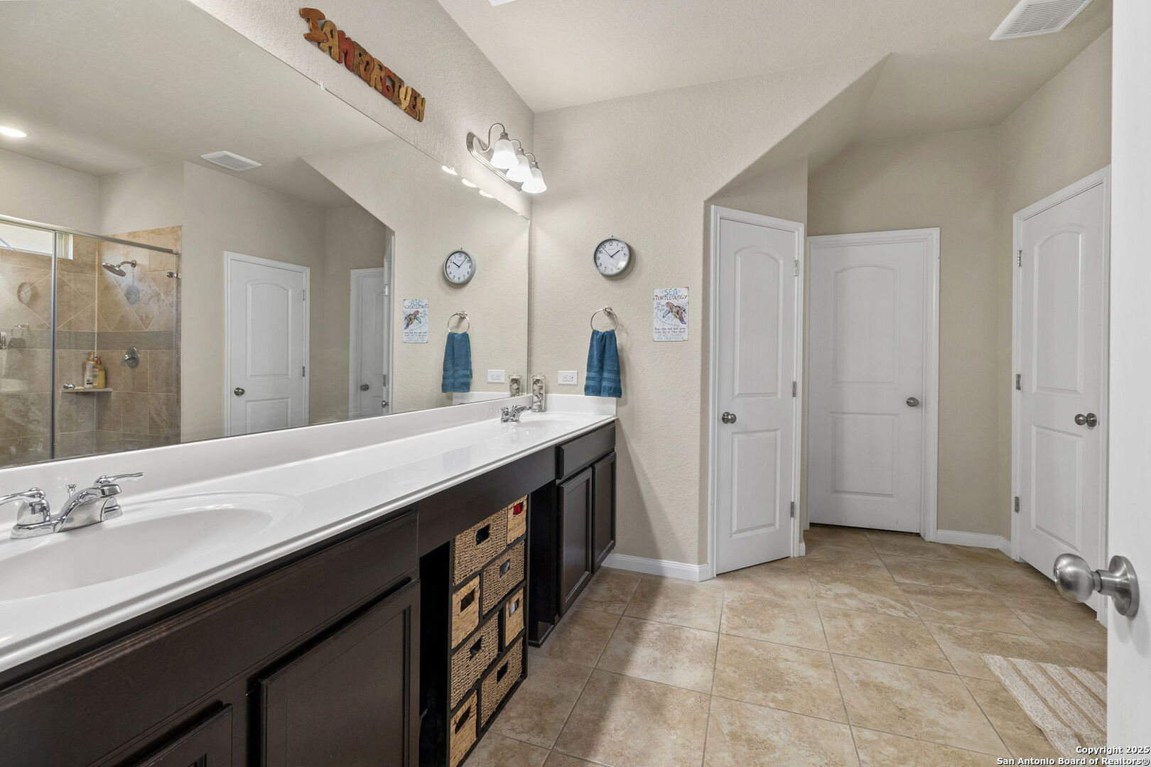 10343 Rosalina Loop Converse, TX 78109 - Photo 21 of 38 a spacious bathroom with a double vanity sink a large mirror and a shower