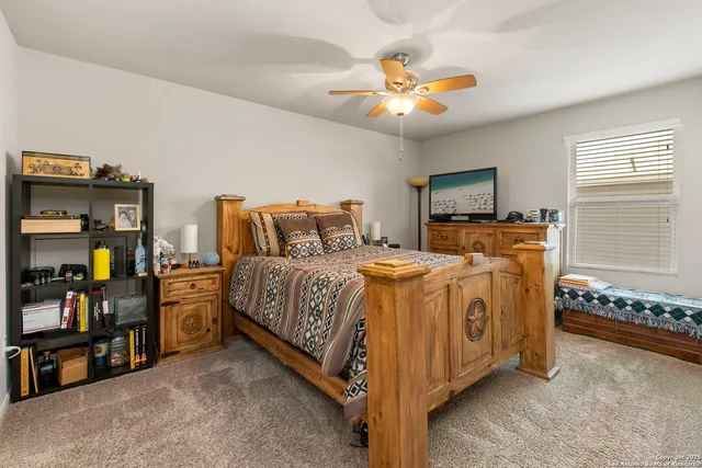 a spacious bedroom with a bed and a chandelier