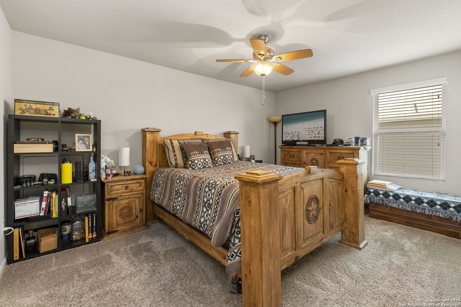 10343 Rosalina Loop Converse, TX 78109 - Photo 29 of 38 a spacious bedroom with a bed and a chandelier
