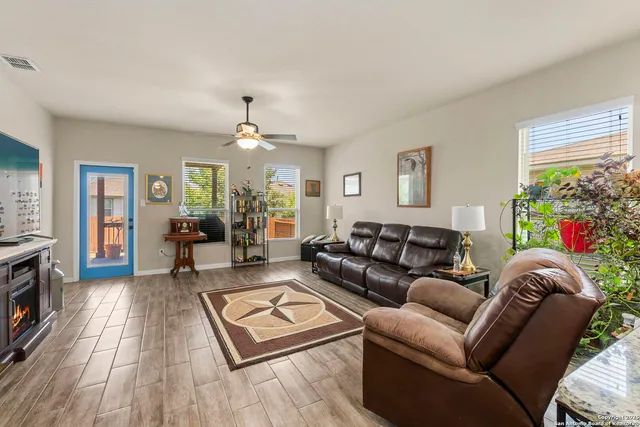 a living room with furniture and a wooden floor