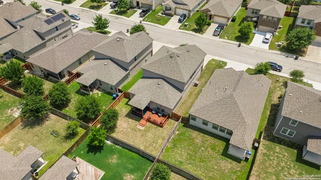 an aerial view of a house with a garden and trees
