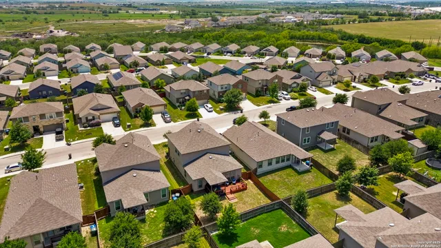 an aerial view of residential houses with outdoor space and swimming pool