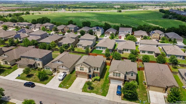 an aerial view of a houses with outdoor space and city view