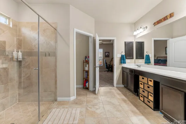 a bathroom with a double vanity sink a mirror and a shower