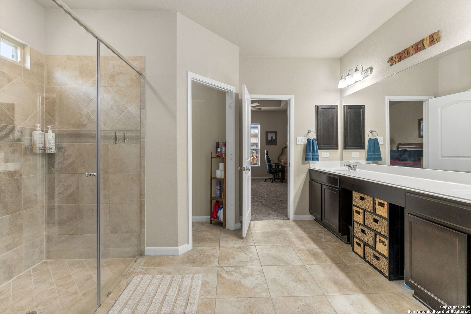 10343 Rosalina Loop Converse, TX 78109 - Photo 8 of 38 a bathroom with a double vanity sink a mirror and a shower