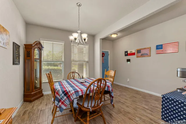 a view of a dining room with furniture wooden floor and chandelier