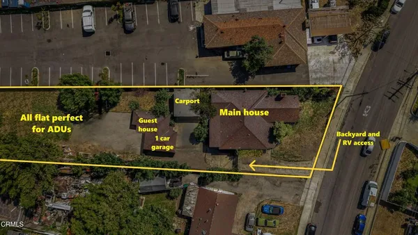 an aerial view of residential houses with outdoor space