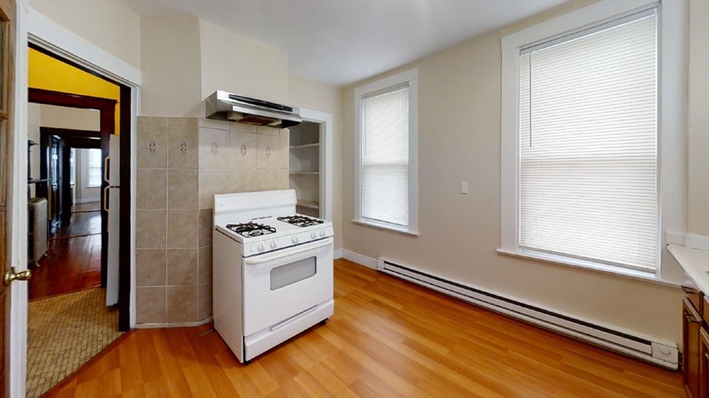 33 Bellingham Street, Unit 2 Chelsea, MA 02150 - Photo 13 of 18 a kitchen with a stove and a refrigerator