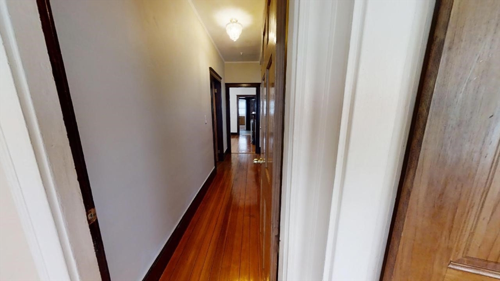33 Bellingham Street, Unit 2 Chelsea, MA 02150 - Photo 8 of 18 a view of a hallway with wooden floor and stairs