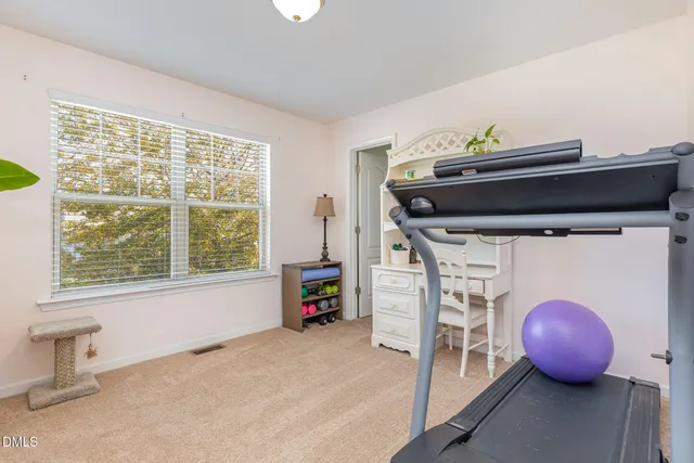 a view of a room with wooden floor and furniture