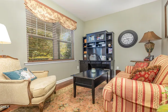 a living room with furniture a window and a table