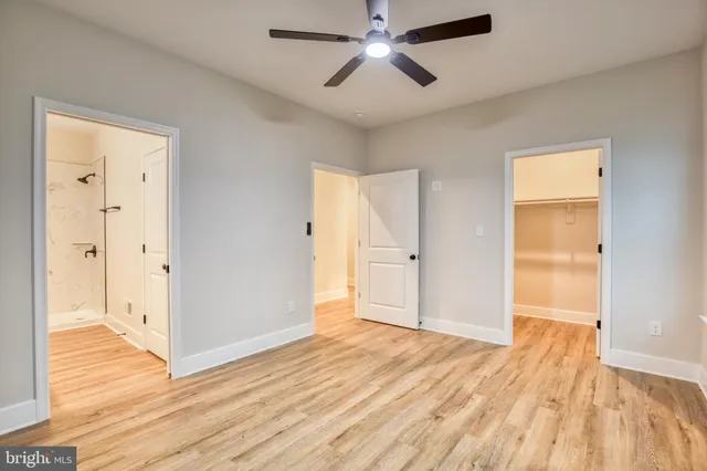 a view of empty room with wooden floor