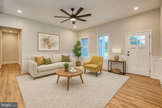 a living room with furniture and a wooden floor