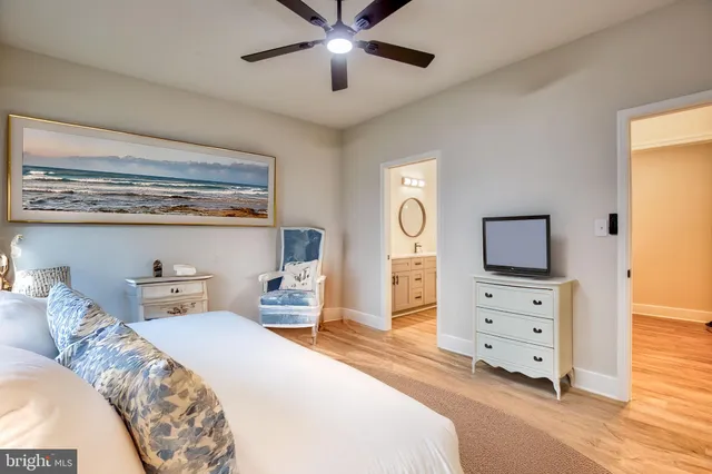 a bedroom with a bed and a tv on the dresser