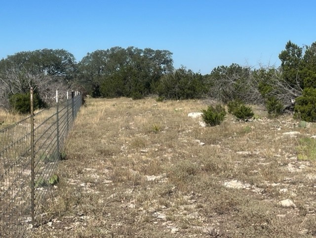 0 SD 73510 Rocksprings, TX 78880 - Photo 18 of 32 a view of a dry yard with trees in the background
