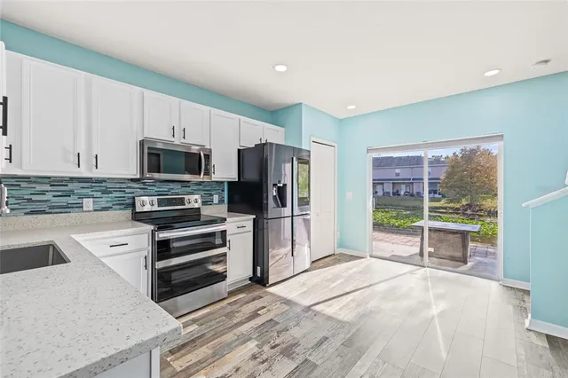 a kitchen with stainless steel appliances a stove microwave and refrigerator