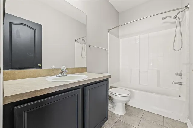 a bathroom with a sink a toilet a mirror and a shower