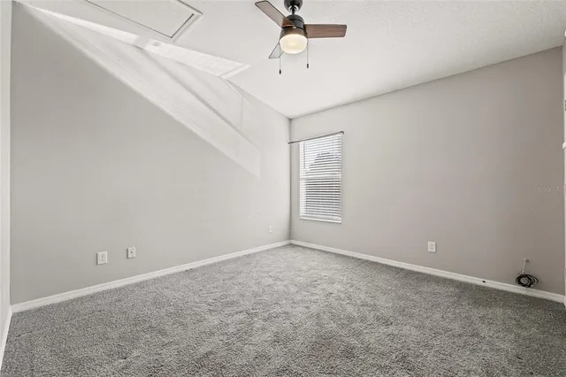 a view of empty room with a ceiling fan