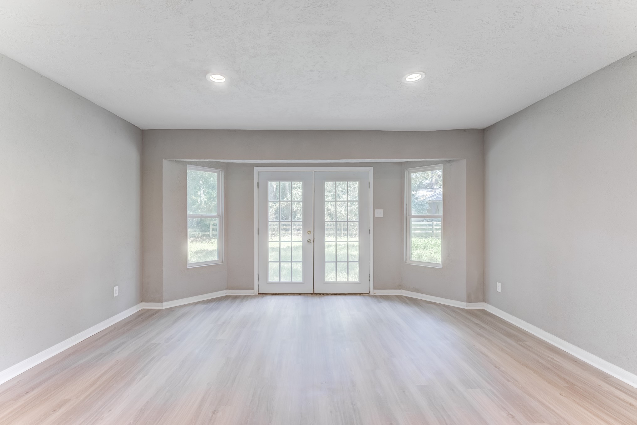 81 Oak Grove Lane Conroe, TX 77304 - Photo 12 of 50 an empty room with wooden floor and windows