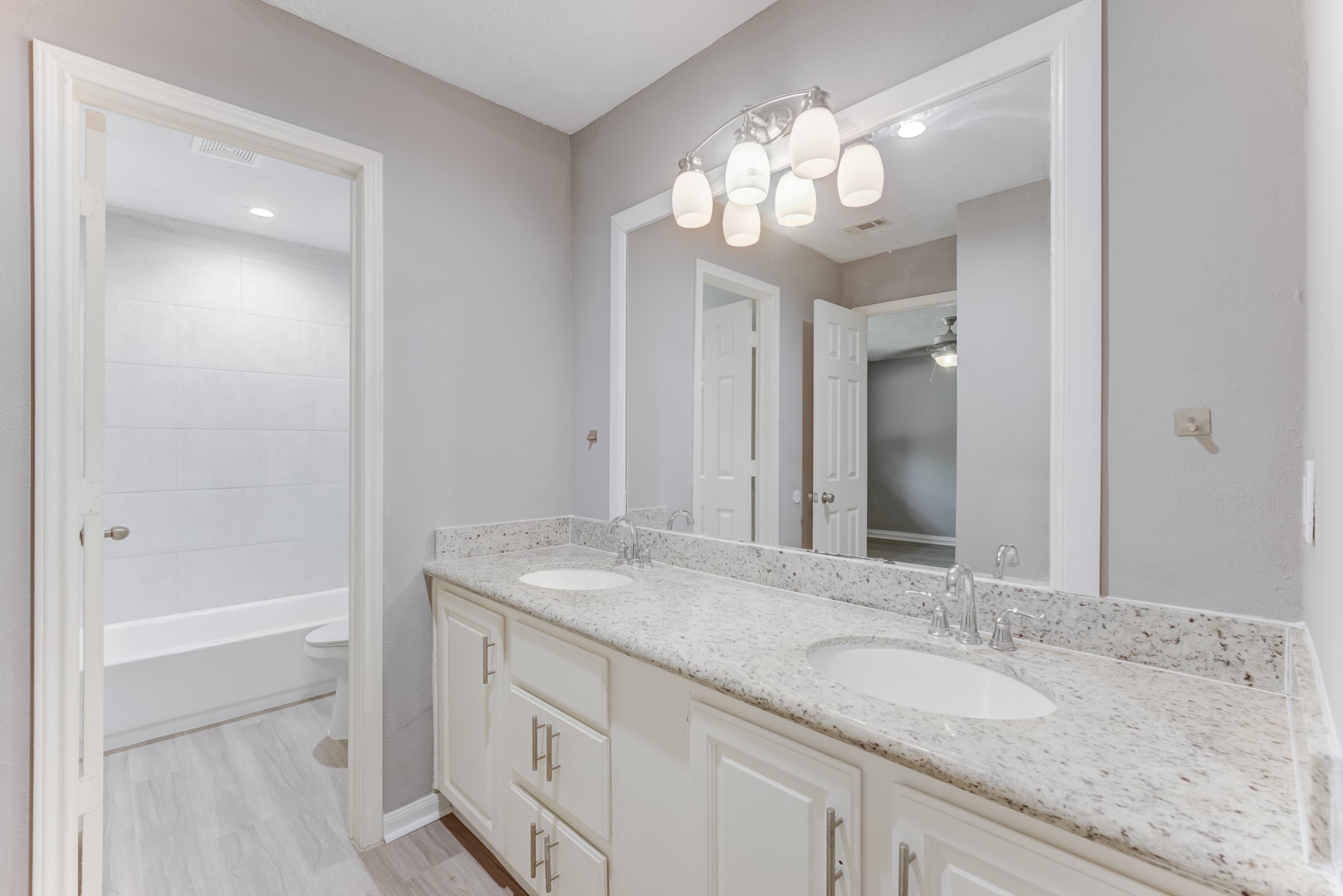 81 Oak Grove Lane Conroe, TX 77304 - Photo 14 of 50 a bathroom with a granite countertop sink a large mirror and a shower