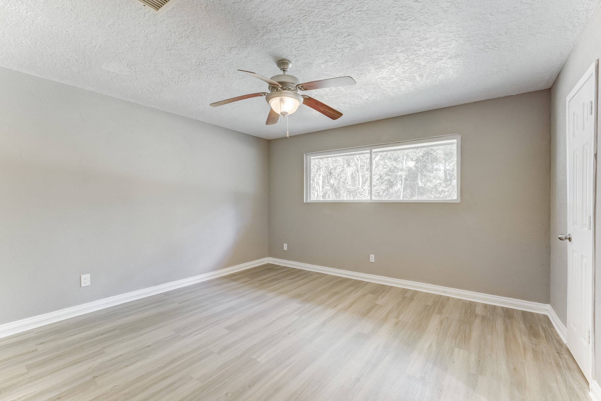 81 Oak Grove Lane Conroe, TX 77304 - Photo 16 of 50 wooden floor in an empty room with a window