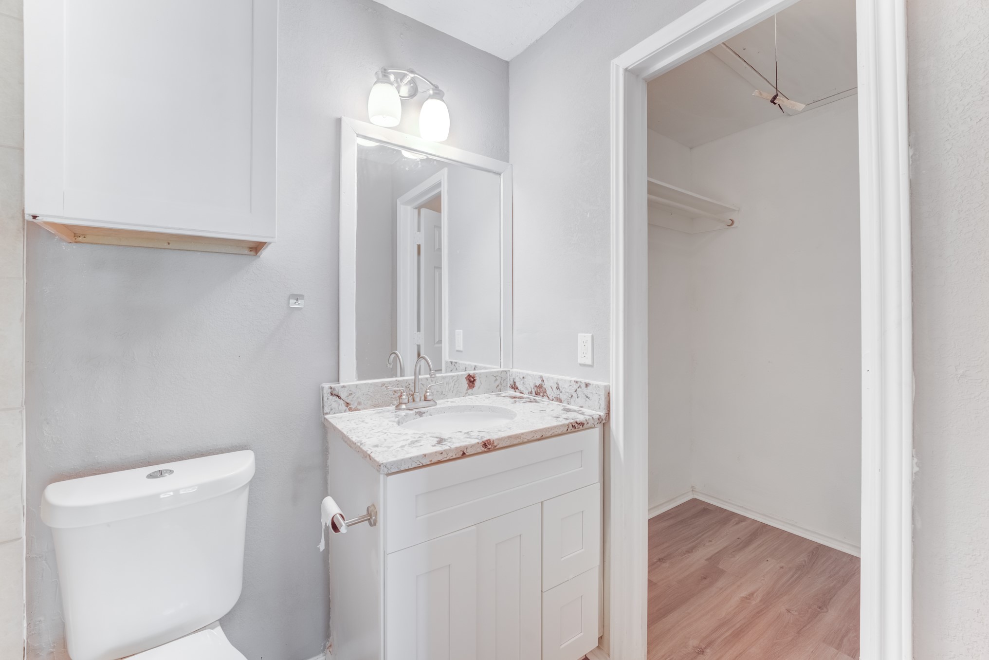 81 Oak Grove Lane Conroe, TX 77304 - Photo 21 of 50 a bathroom with a sink a toilet and a mirror