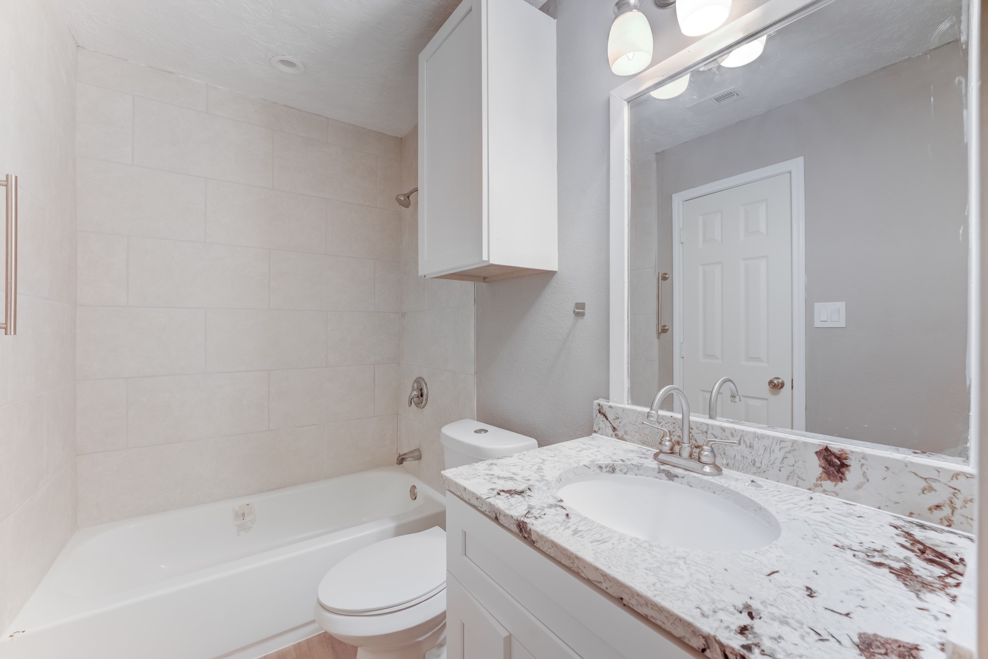 81 Oak Grove Lane Conroe, TX 77304 - Photo 22 of 50 a bathroom with a granite countertop sink a toilet and bathtub