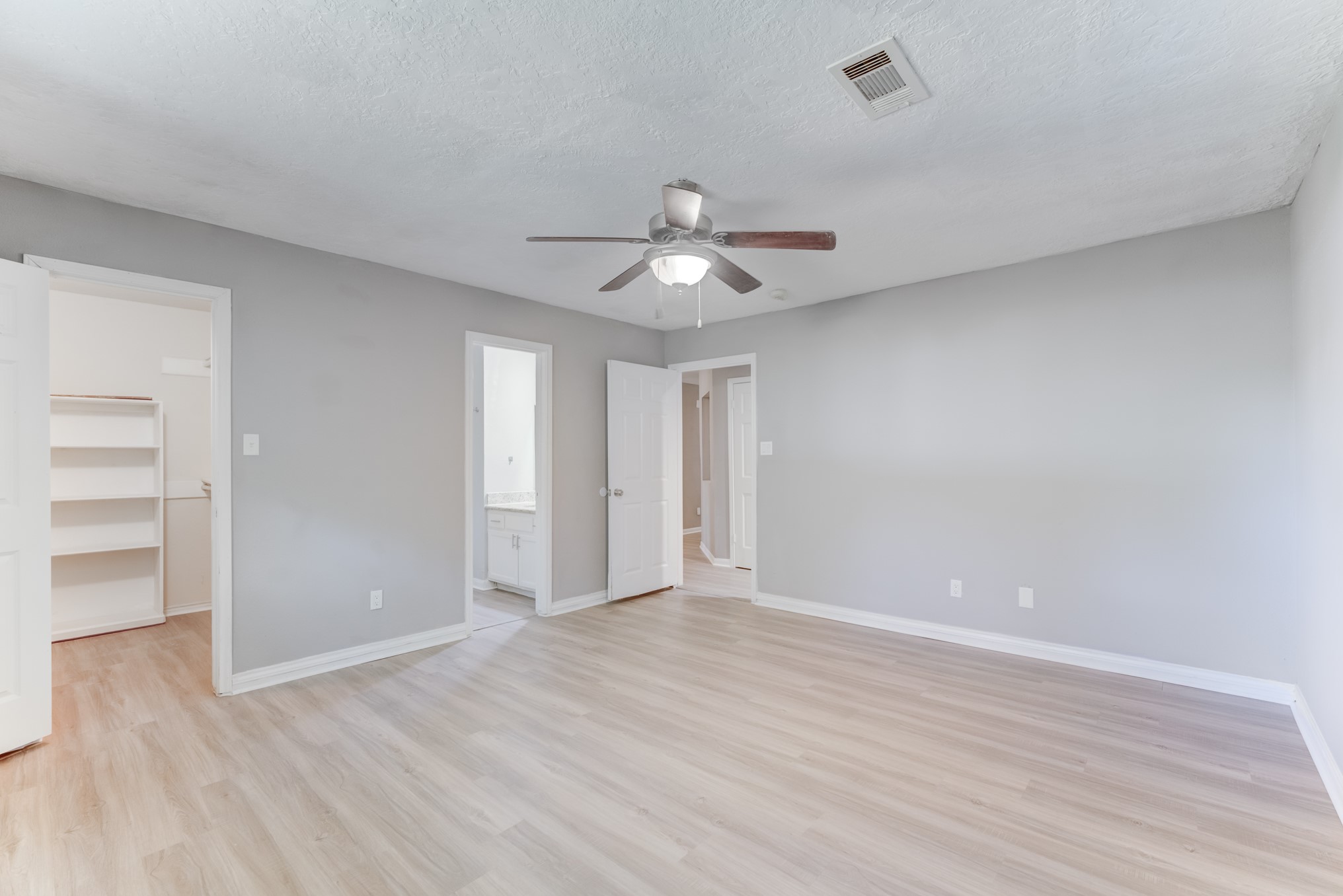 81 Oak Grove Lane Conroe, TX 77304 - Photo 24 of 50 a view of an empty room and a ceiling fan window