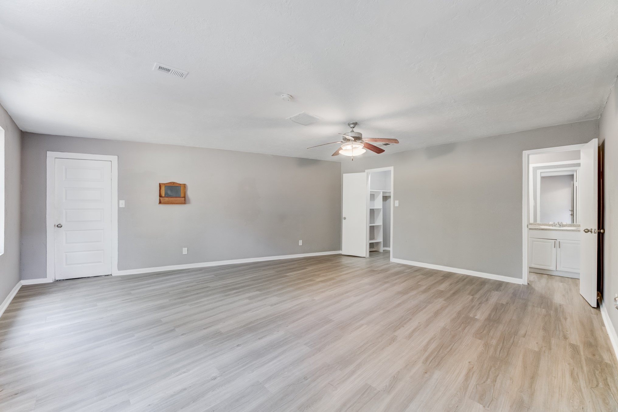 81 Oak Grove Lane Conroe, TX 77304 - Photo 33 of 50 a view of an empty room with wooden floor