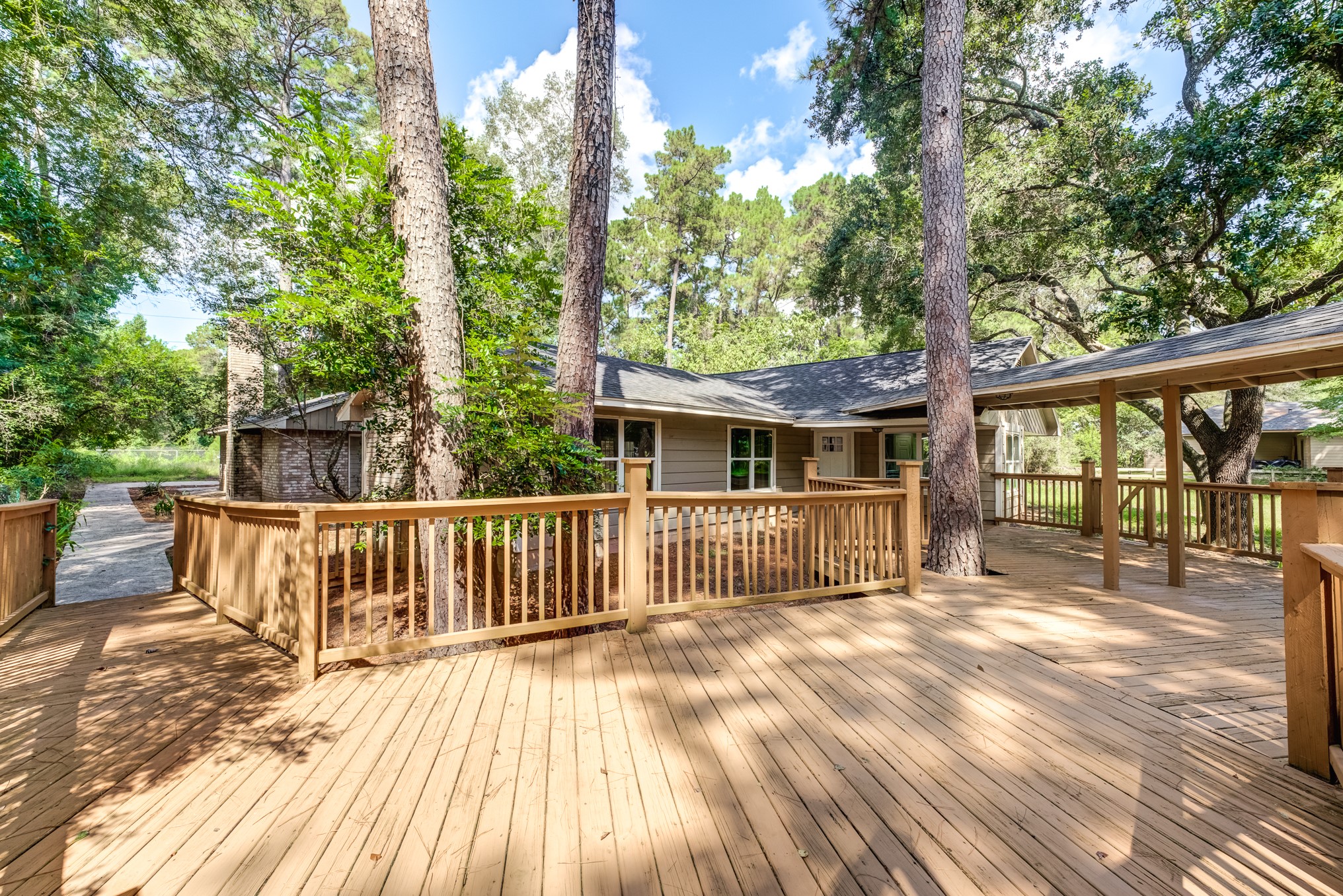 81 Oak Grove Lane Conroe, TX 77304 - Photo 42 of 50 a view of a deck with a floor to ceiling window next to a yard