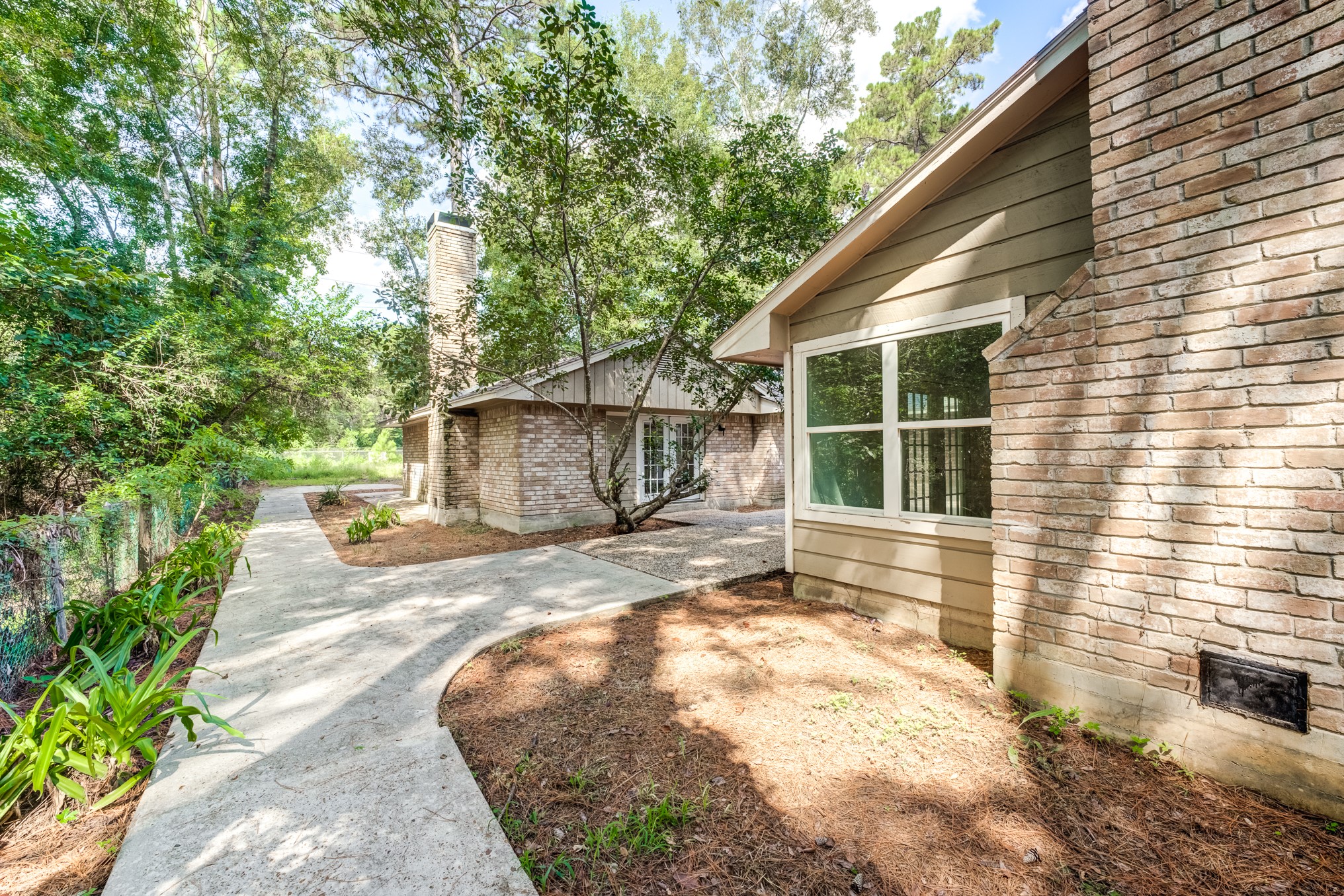 81 Oak Grove Lane Conroe, TX 77304 - Photo 43 of 50 a view of a house with backyard and sitting area