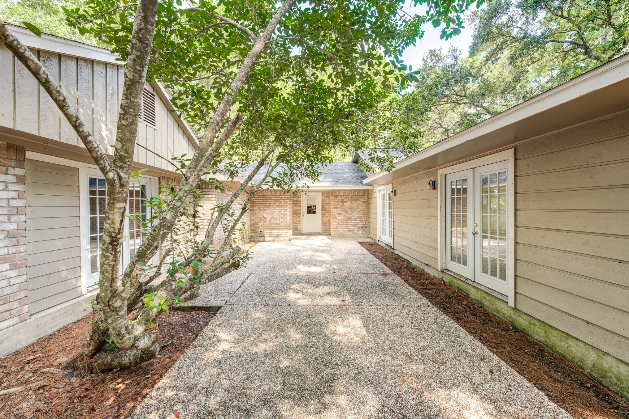 81 Oak Grove Lane Conroe, TX 77304 - Photo 44 of 50 a front view of a house with a yard and garage