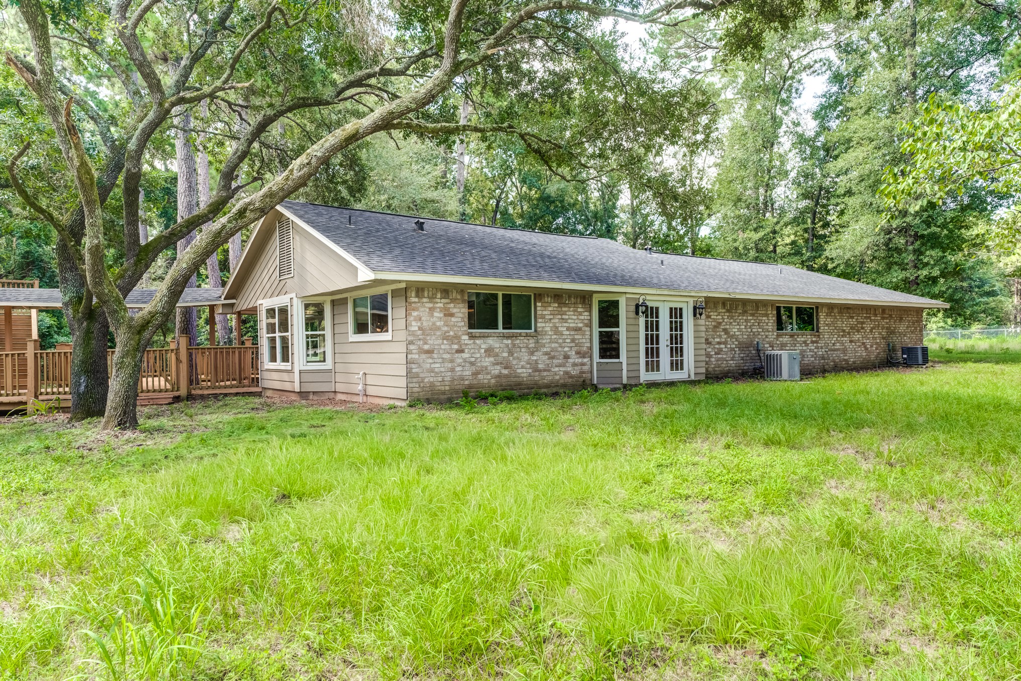 81 Oak Grove Lane Conroe, TX 77304 - Photo 49 of 50 a view of a house with a backyard