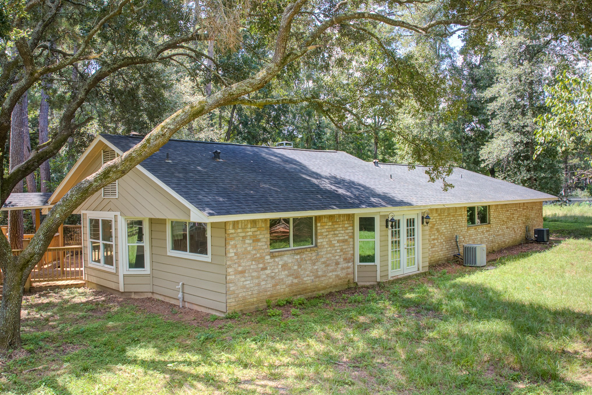 81 Oak Grove Lane Conroe, TX 77304 - Photo 50 of 50 a view of a yard in front of a house with large trees