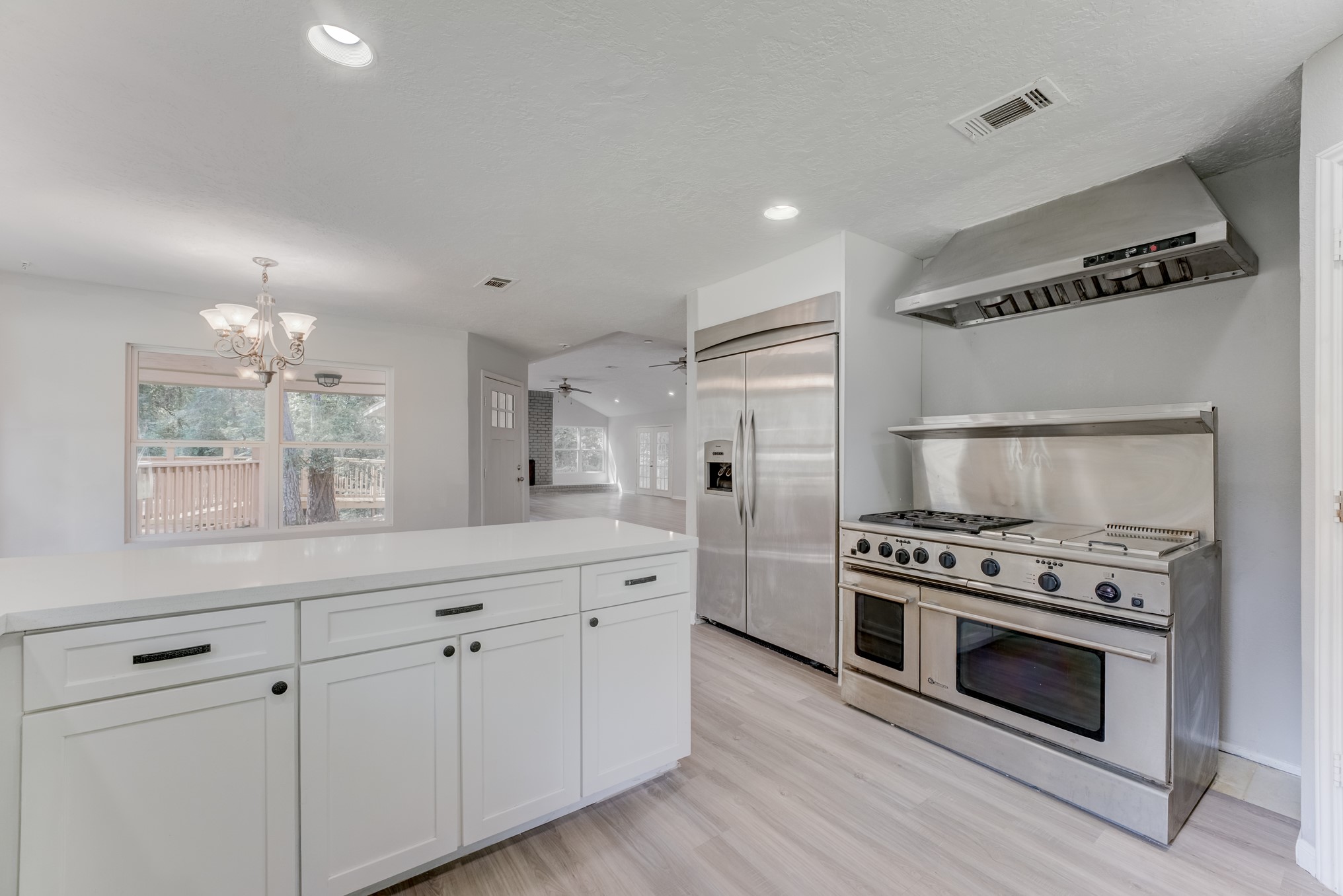 81 Oak Grove Lane Conroe, TX 77304 - Photo 6 of 50 a kitchen with white cabinets and stainless steel appliances