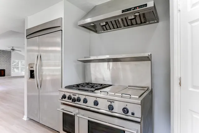 a kitchen with a stove and a refrigerator