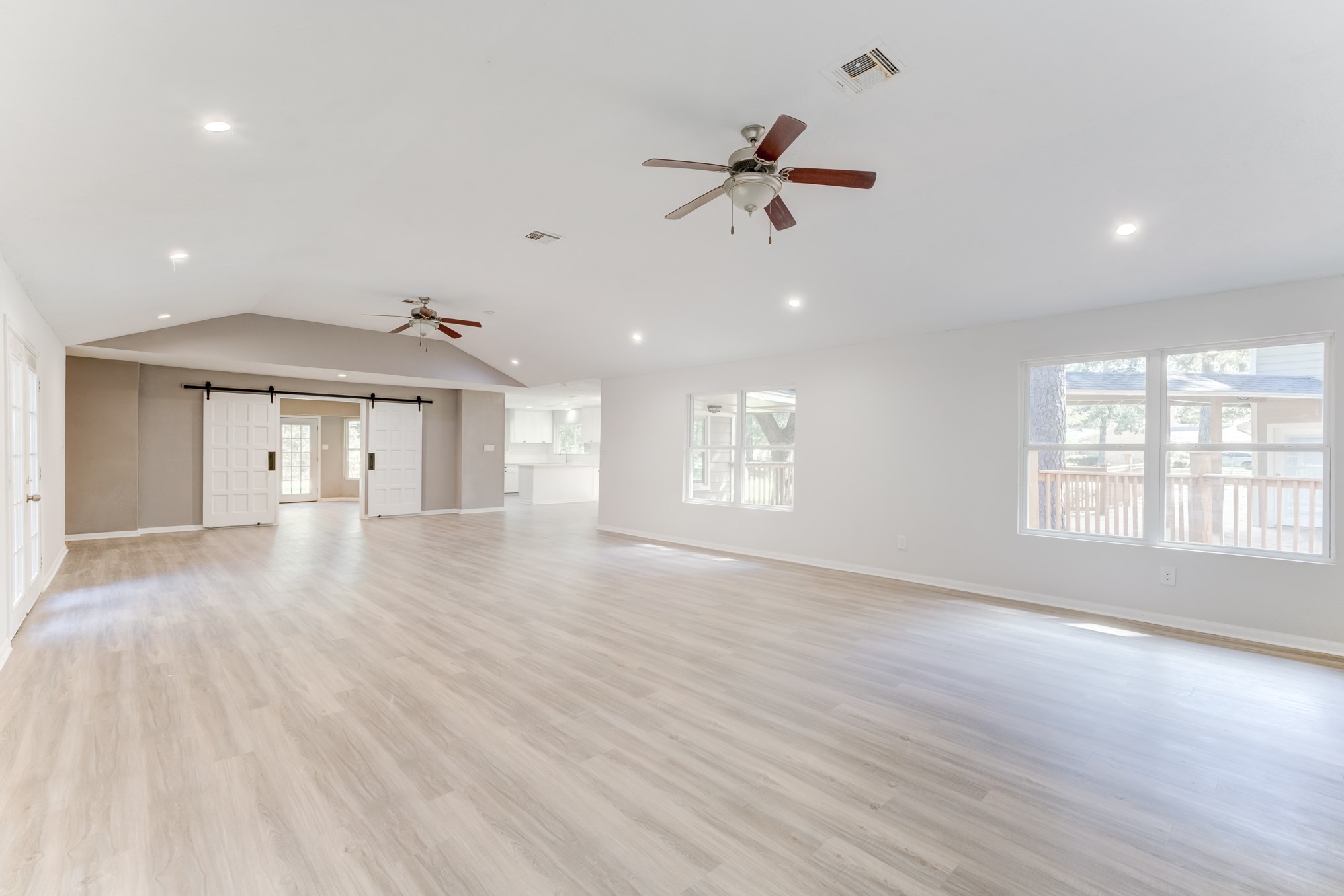 81 Oak Grove Lane Conroe, TX 77304 - Photo 10 of 50 a view of an empty room with a window and wooden floor