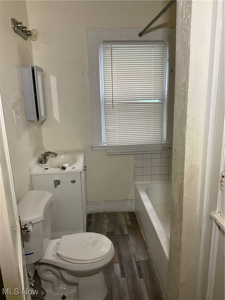 876 Paxton Road Cleveland, OH 44108 - Photo 11 of 26 Bathroom featuring baseboards, vanity, toilet, and wood finished floors