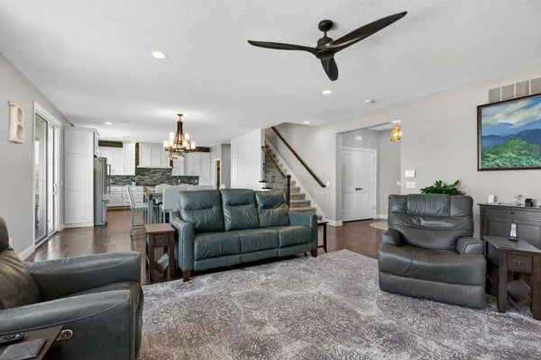 a kitchen with stainless steel appliances granite countertop a sink a stove and refrigerator