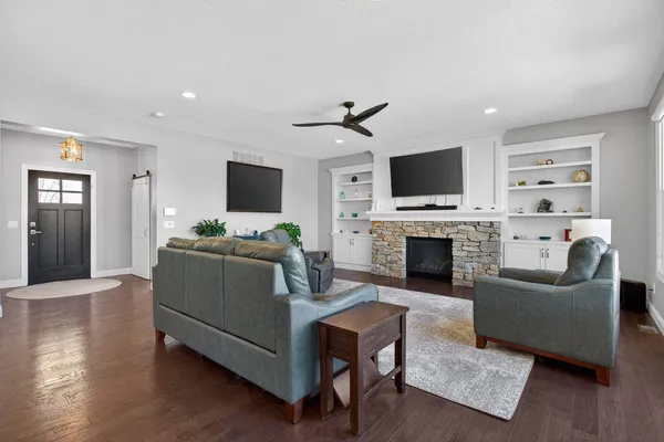 a kitchen with granite countertop a table chairs stove and cabinets