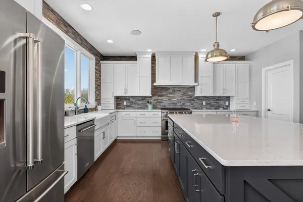 a large kitchen with a table and chairs