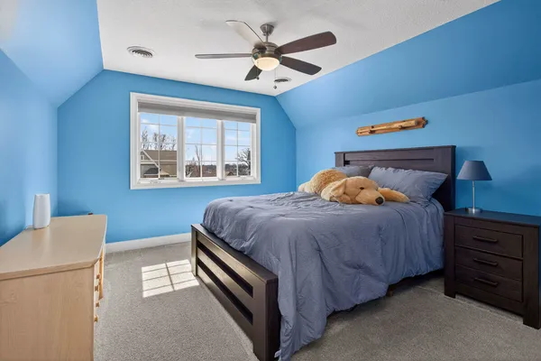 a bedroom with a bed and a dresser