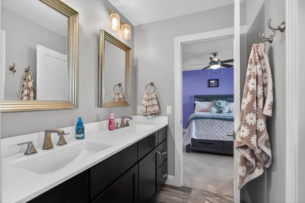 a white bath tub sitting next to a white sink and glass door