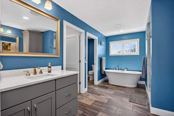 a bedroom with a large bed and a window