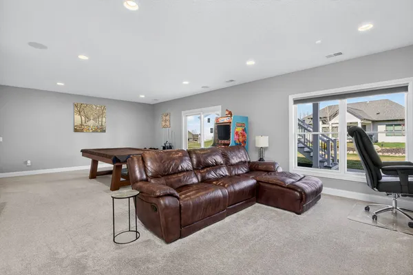 an aerial view of a city with lots of residential buildings ocean and mountain view in back