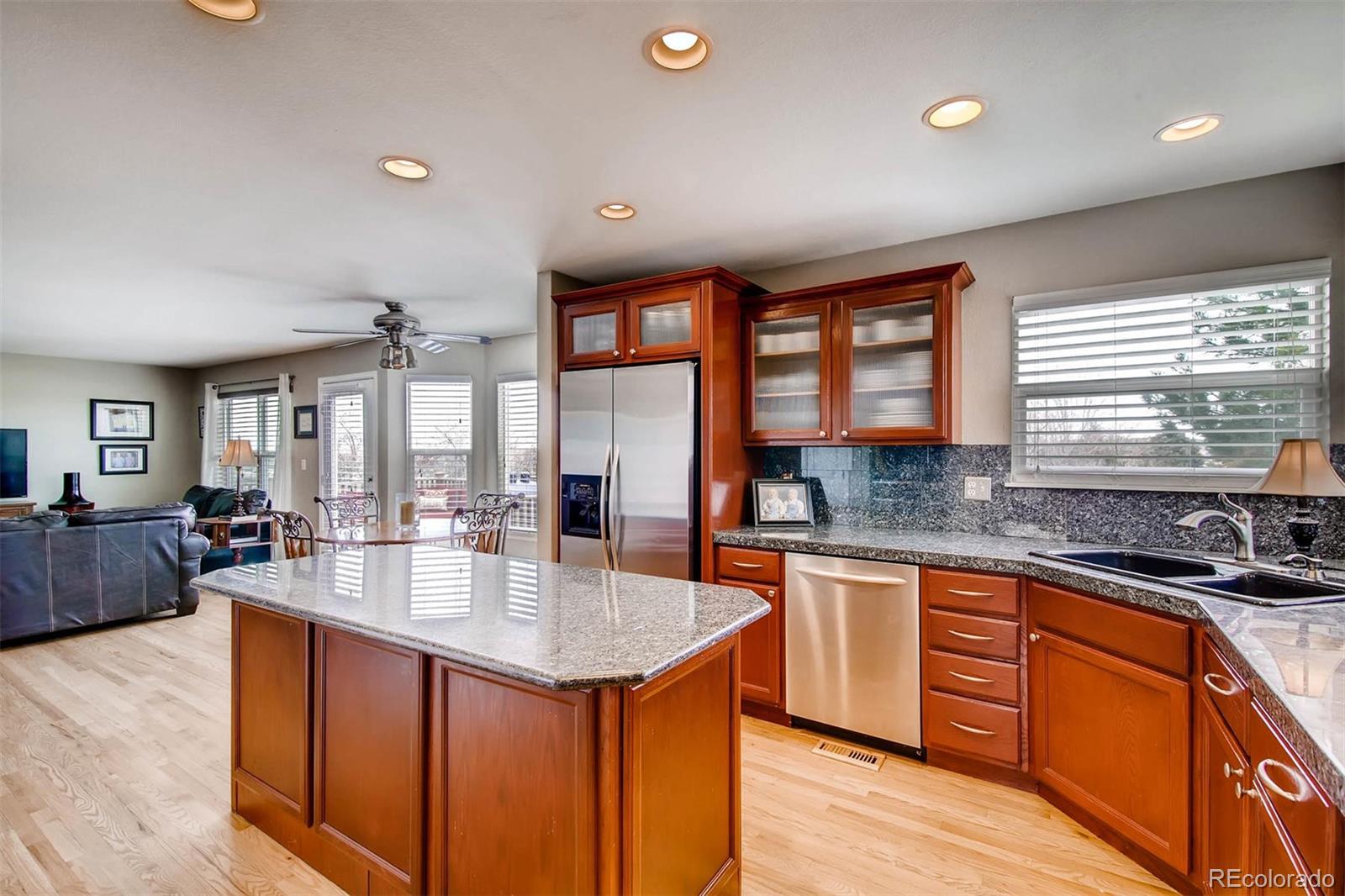 1665 Spring Water Lane Highlands Ranch, CO 80129 - Photo 12 of 34 a large kitchen with kitchen island granite countertop a sink and cabinets